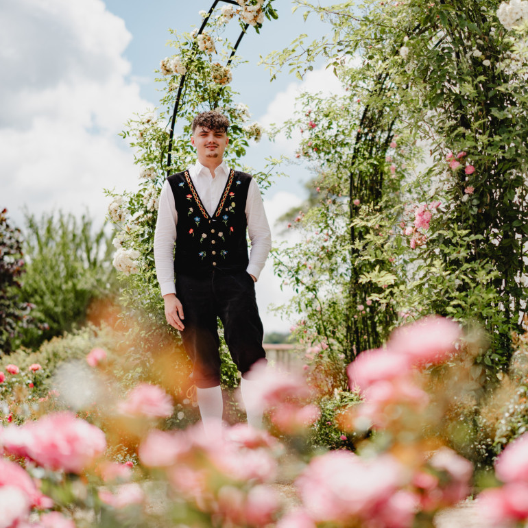 Der Rosenkönig Freddy steht im Rosengarten
